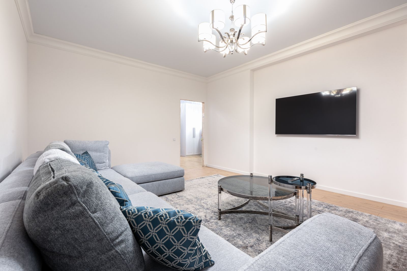 Bright living room with a large wall-mounted flat-screen TV